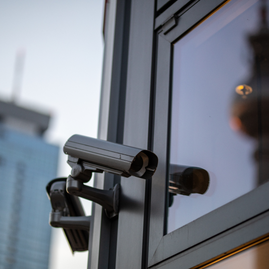 low-angle-view-security-camera-building-against-sky-sunse.png